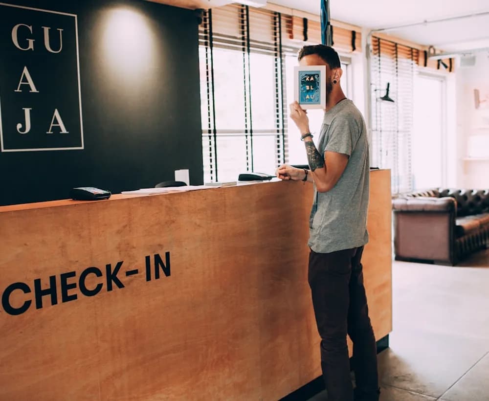 A guest presenting identification at a reception check-in desk